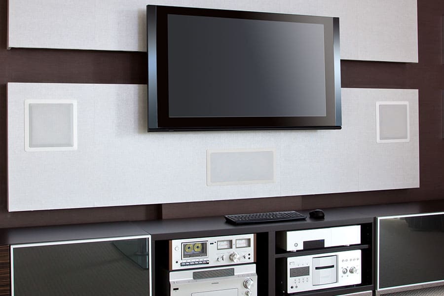 Wall-mounted speakers surround the big-screen TV with sound